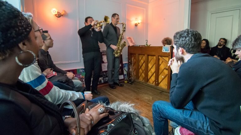 People playing jazz in a small apartment.